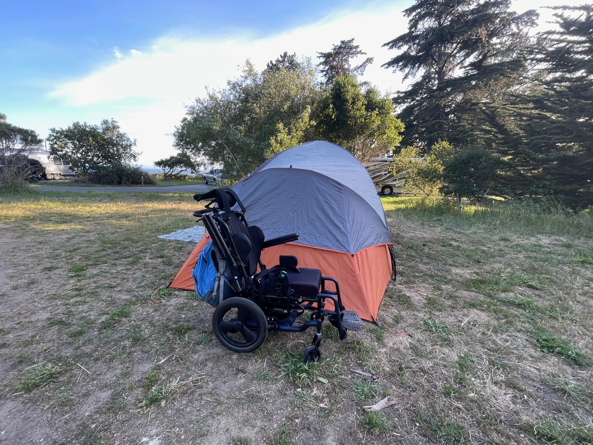 Wheelchair beside a tent at a campsite